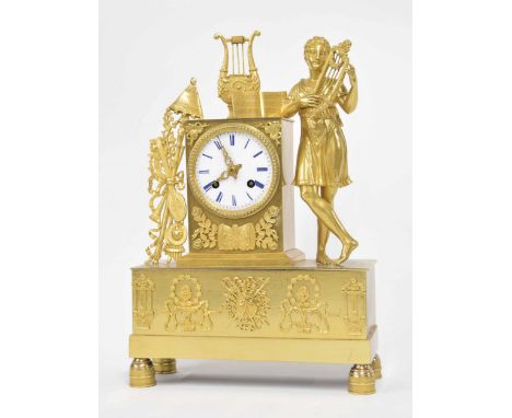 French ormolu Empire mantel clock emblematic of music, the 3.25" white enamel dial inset into a classical pillar surmounted b