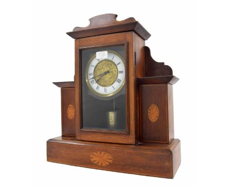Unusual electric mantel clock, the 5" white chapter ring enclosing a foliate embossed centre, within a mahogany inlaid shelve