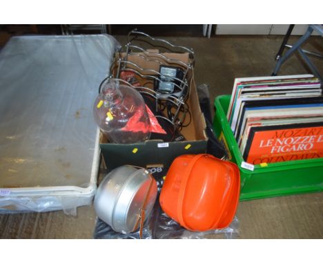 A box containing a halogen light, demi john, wine rack, etc.