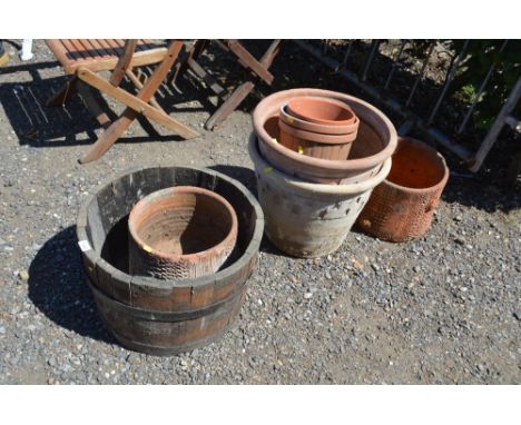 A half barrel planter; and a quantity of terracotta and other planters 