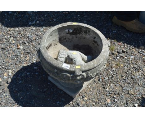 A concrete garden planter; and a concrete squirrel ornament