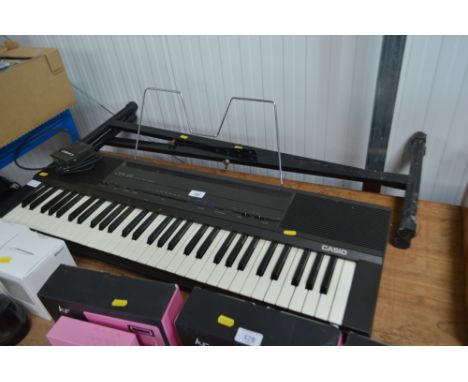 A Casio keyboard on stand lacking power lead