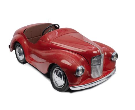 An Austin J40 pedal car, British,no chassis number visible to rear boot panel, pressed steel body painted red, chromed bright