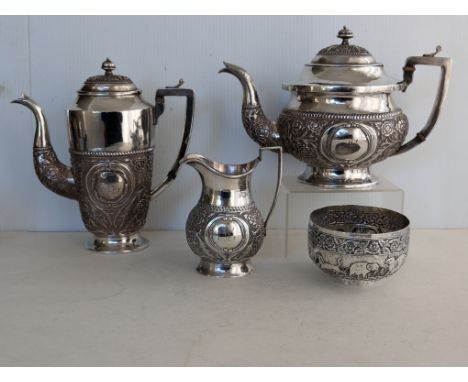 An early 20th century Indian silver three-piece tea and coffee service with a similar sugar bowl, unmarked but testing for si