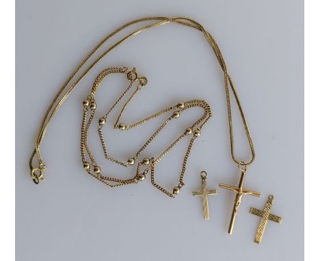 An 18ct yellow gold crucifix pendant chain, hallmarked, 4.6g;  a 9ct yellow gold neck chain with ball decoration, 50 cm and t