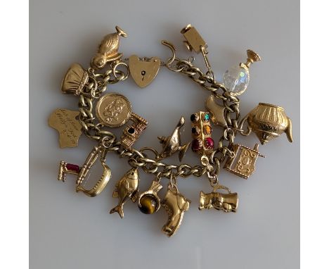 A 9ct yellow gold charm bracelet, all hallmarked, 63.5g