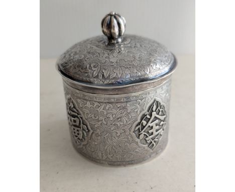 An early 20th century Chinese silver cylindrical box with domed lid, gilt interior, melon finial, with profuse seaweed etchin