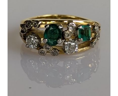 A vintage emerald and diamond dress ring on an 18ct yellow gold split shank, largest diamond approximately 0.15 carats, size 