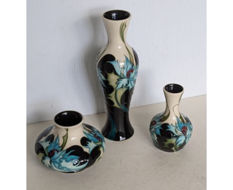 A Moorcroft 'Sea Holly' pattern baluster vase, bud vase and squat vase, all designed by Emma Bossons, impressed and painted m