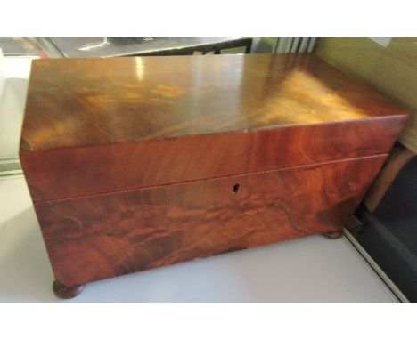 A Victorian figured mahogany rectangular tea caddy on flat bun feet