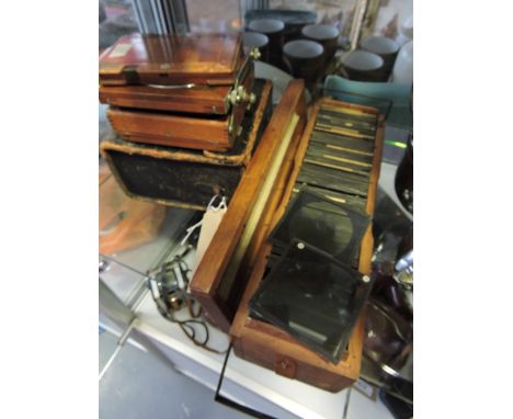 An early 20th Century German, Compur chrome mounted mahogany quarter plate bellows camera, cased together with a collection o