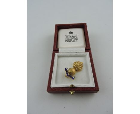 A 9ct gold ladies Royal Artillery grenade pin with blue enamel scroll, in Garrard & Co. retail box, 4.5g.
