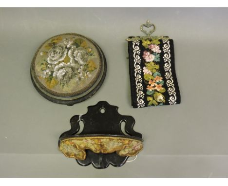 A Victorian ebonised wall shelf, semi-circular with a gros-point pendent apron, H. 26cm, together with a circular foot stool 