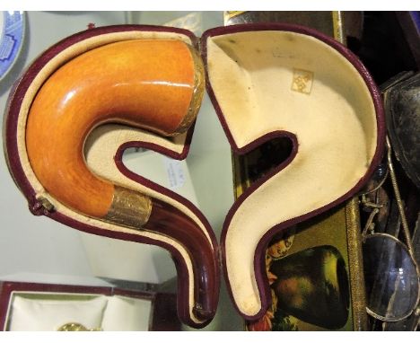 An early 20th Century 9ct gold mounted Meerschaum pipe with amber mouthpiece, cased, together with four cased carved Meerscha