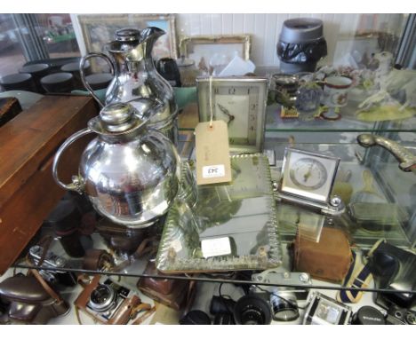 A 1950s Bentina chrome mantle clock together with a desk top barometer, chrome thermos flasks, and an easel dressing table mi