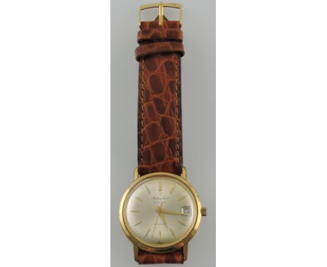Mathey-Tissot & Co., SA. A mid 20th century gentleman's yellow metal dress watch, having a champagne baton dial with date ape