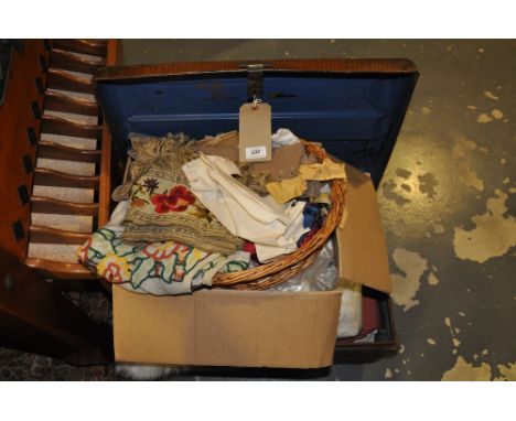A Victorian metal trunk containing a quantity of assorted textiles, furs and embroideries