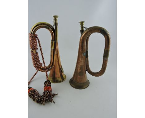 A copper and brass bugle, together with another bearing an armorial, (2). 