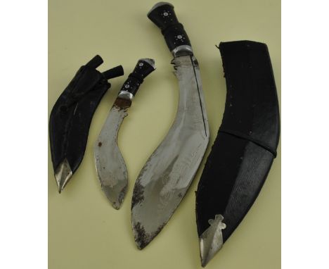 A 20th century Kukri with chrome plated blade and black leather scabbard, together with another similar smaller, (2).