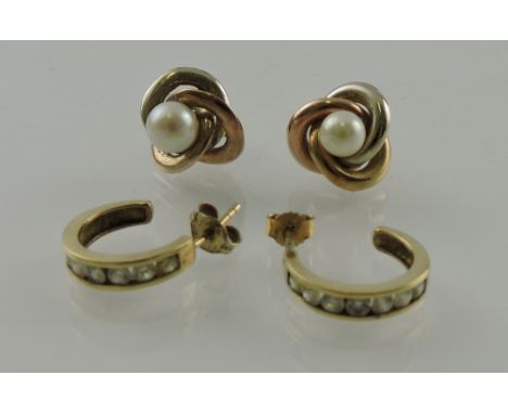 A pair of yellow metal and pearl ear studs, together with another pair set with white stones, both stamped 375, 6.4g.