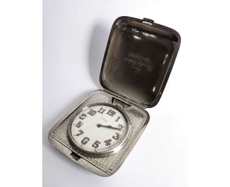 An early 20th century sterling silver-cased eight-day travelling clock; white-enamel dial (hairlines) with Arabic numerals an