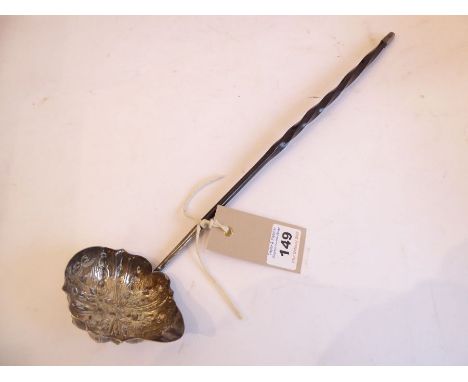 An early 19th century hallmarked silver toddy ladle. Barleytwist-style whalebone handle; the bowl decorated in repoussé style