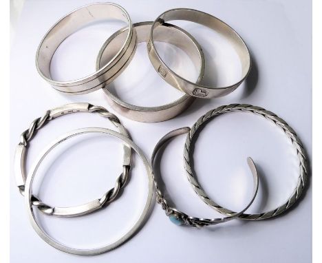 Six hallmarked silver bangles and a torc bangle stamped 'STERLING', centrally-set with an oval turquoise cabochon (combined g