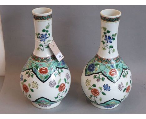 A good pair of Kangxi-style Chinese porcelain bottle vases (19th century); hand-decorated in famille verte enamels with flora