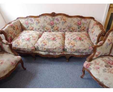 A large and fine carved oak and upholstered three-seater sofa in Louis XV style; the ornately carved show wood detailing acan