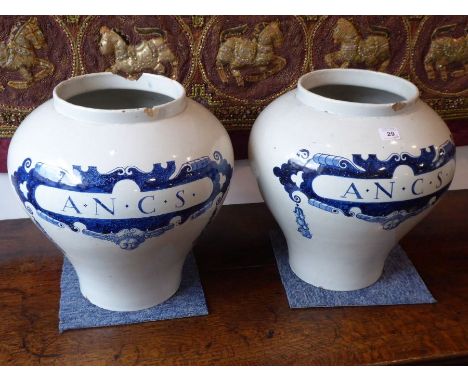 A pair of early style (early 20th century) large Dutch Delft baluster-shaped cannisters (possibly tea); each marked in cobalt
