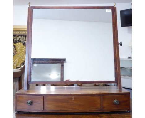 A large early 19th century bow-fronted mahogany and boxwood-strung toilet mirror; the tapering vertical boxwood-strung uprigh