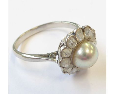A pearl and diamond-set cluster ring, the 7mm central pearl (untested) to the cushion-shaped old-cut diamond surround, size M