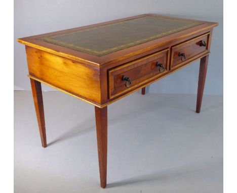 A miniature yew wood writing table in George III style; the gilt-tooled green-leather inset writing surface above two mahogan