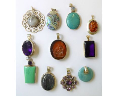 A good and interesting selection of eleven various silver pendants; some set with semi-precious stones, one large hand-cut ov