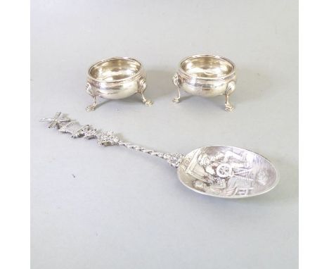 A pair of mid-18th century hallmarked silver circular salts and a later Dutch silver spoon. The salts&nbsp;with tripod legs, 
