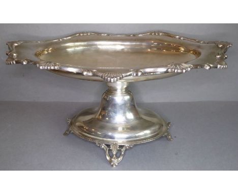 A fine, large and heavy early 20th century hallmarked silver pedestal comport; the raised border cast with C scrolls and shel