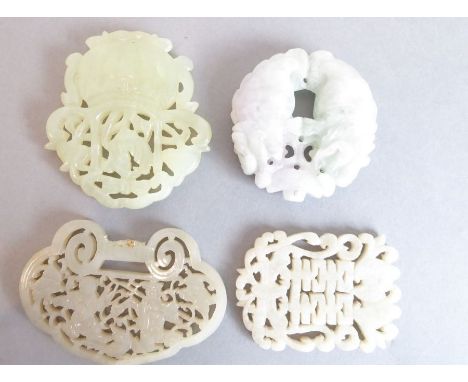 Three carved Chinese hardstone (possibly jade) pendants; one shaped as a ruyi head (7.5cm), one other with carved shou charac