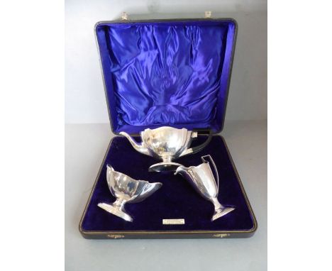 A fine three-piece, hallmarked silver, neoclassical inspired&nbsp;tea service: teapot, boat-shaped sugar and milk jug. The su