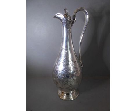 A very fine and large mid-19th century hallmarked silver claret / wine jug. The lid with cast finial modelled as oak leaves a