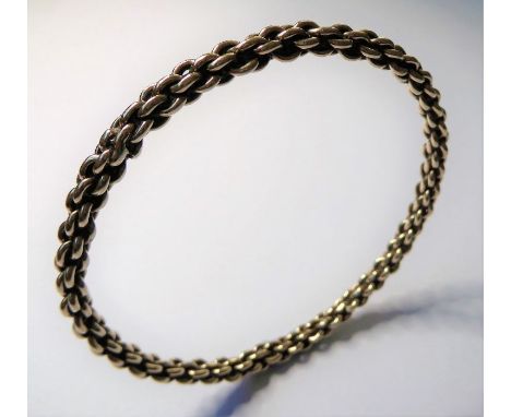 A 9-carat yellow gold oval link rigid bangle; Birmingham hallmark (inner diameter 6.5cm, 23.5g)