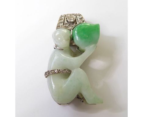 An Art Deco, jadeite and diamond-set single clip brooch; the carved jadeite seated monkey holding a fruit with diamond-set be