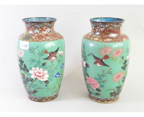 A pair of Japanese cloisonné&nbsp;vases, circa 1880; each with flowers and birds against a jade-green ground (24cm high)