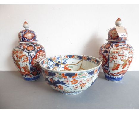 A pair of Imari vases and covers with panels of flaming pearls on a ground of chrysanthemums. Together with a circa 1670 Imar