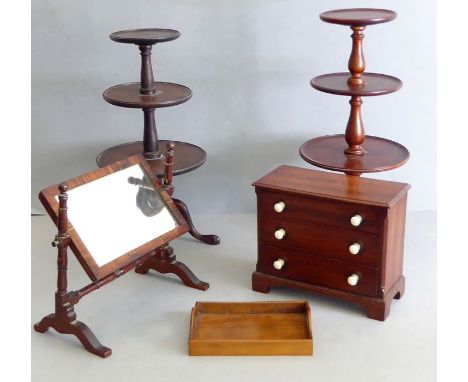 Five pieces of miniature furniture: two three-tier circular mahogany dumb waiters in mid-18th century style and on tripod bas