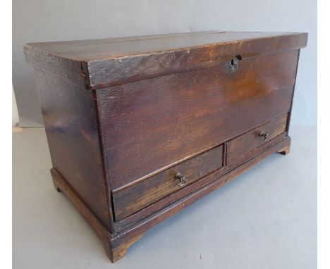 A&nbsp; miniature&nbsp;oak mule chest in late 18th century style; the hinged top above two half-width drawers with axe-head-s