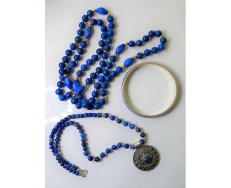 Three items of lapis lazuli jewellery: a spherical bead necklace with occasional tumbled nuggets and roundel spacers; a gradu