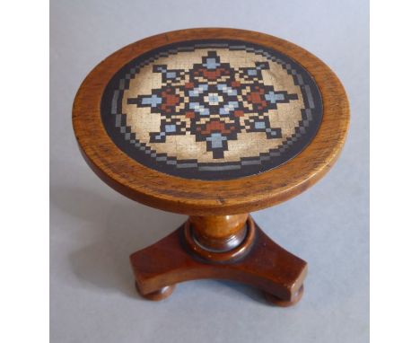 A miniature marble-topped, circular,&nbsp;mahogany occasional table; turned stem and triform base with bun-style feet, the mi