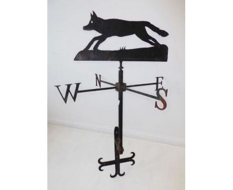 A wrought iron weather vane surmounted with a running fox in profile, custom made by a local blacksmith in Tysoe, (76cm wide 