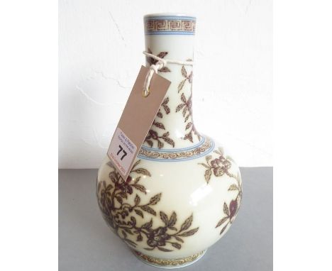 A Chinese porcelain bottle vase in Qianlong style (later). The lip with a key fret pattern above floral sprigs. The main body
