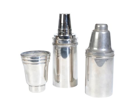 A TRAVELLING COCKTAIL SET the shaker opening to reveal cups, a lemon squeezer and three neatly secured bottles, 28cm high, wi